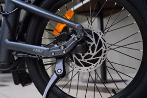 An e-bike with tools and maintenance items on a workbench.