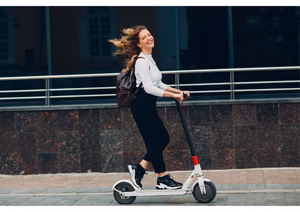 A group of e-scooter riders practicing safe etiquette in an urban area.
