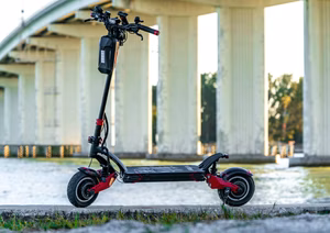 A close-up of an e-bike battery being tested with tools.
